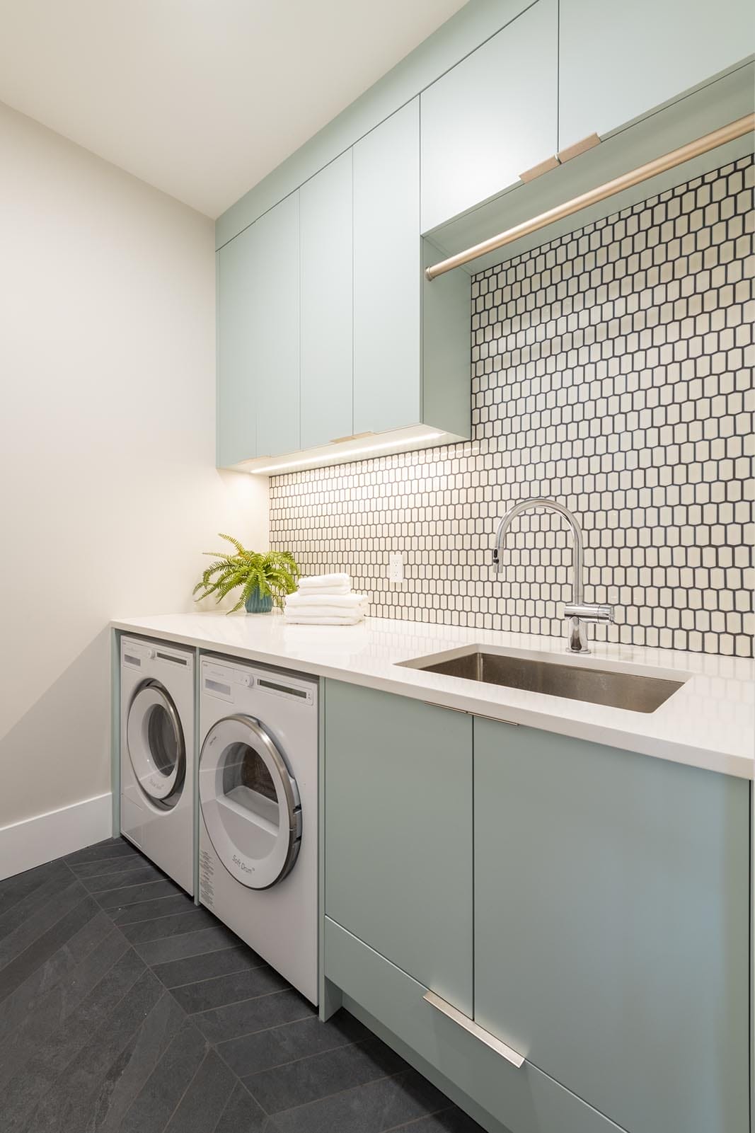 custom home laundry room with tile and marble counter
